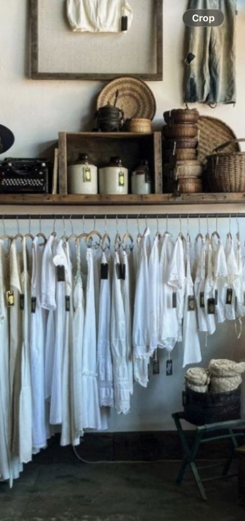 Inside Fringe Vintage — clothing rack with curated vintage pieces